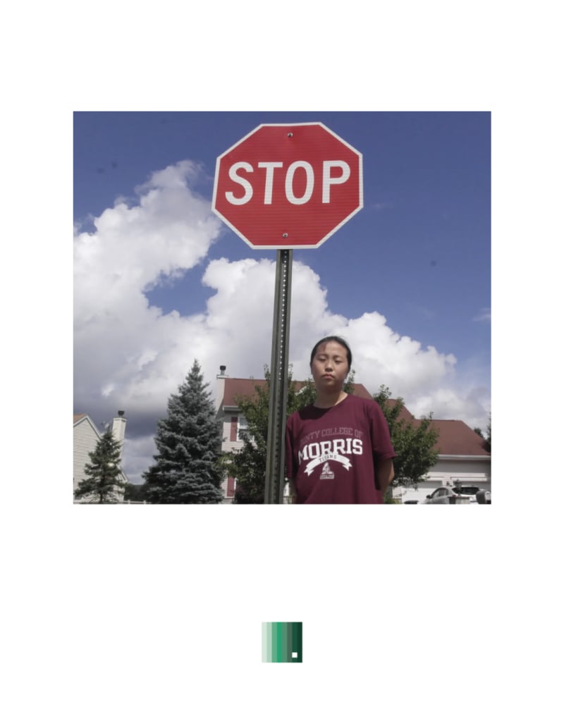 A stop sign against a cloudy blue sky